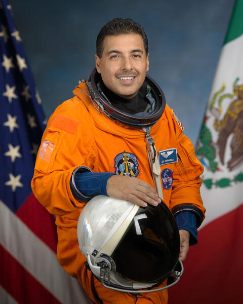 Jose M. Hernandez in Astronaut uniform with US and Mexican flags